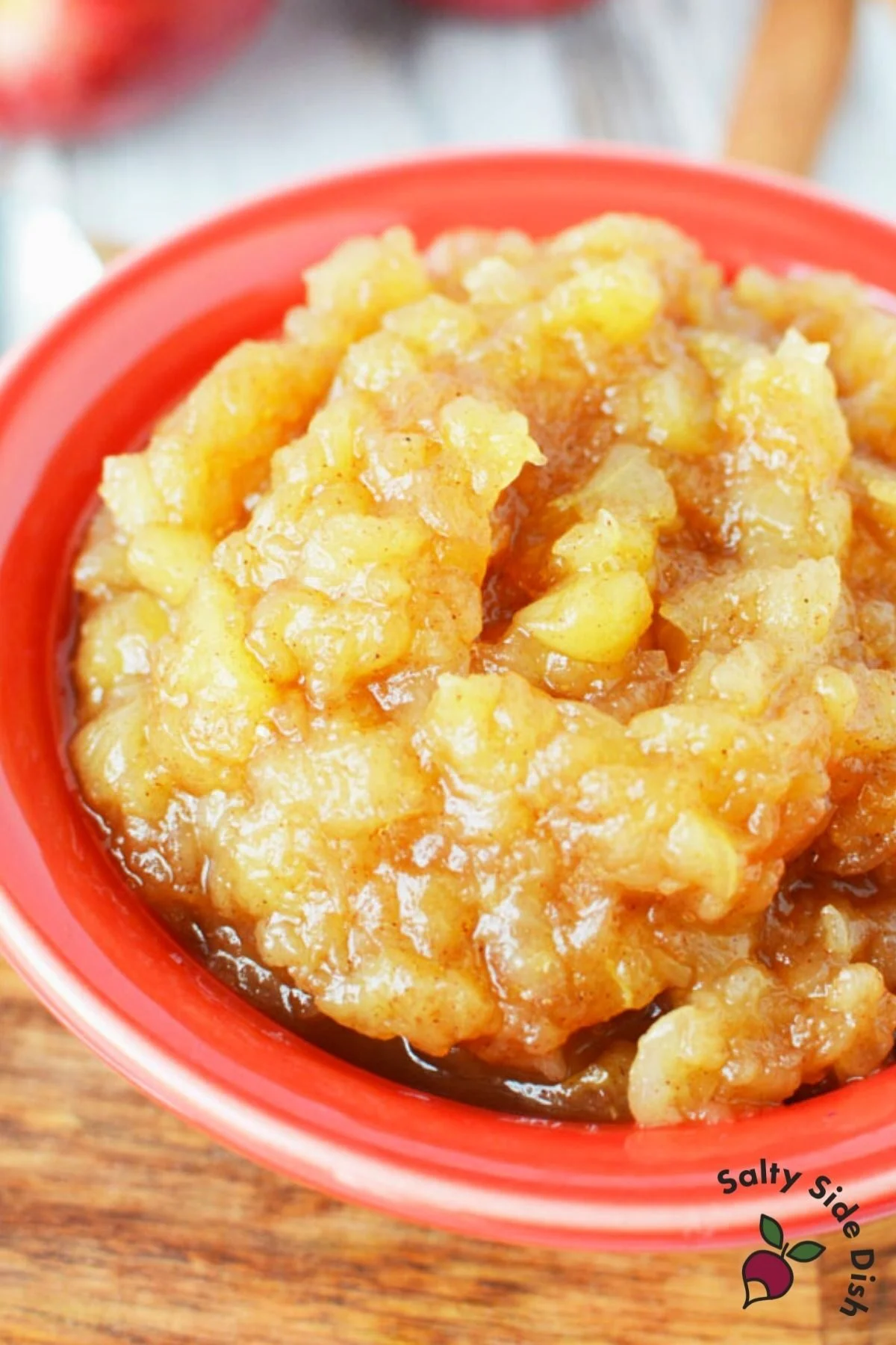 close up image of homemade applesauce in a red bowl.