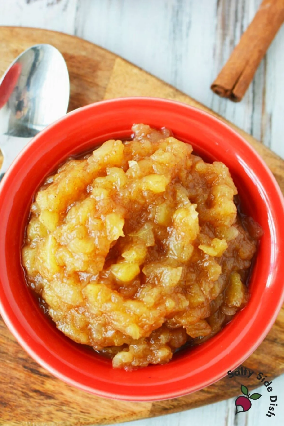 bowl of homemade applesauce next to a spoon.
