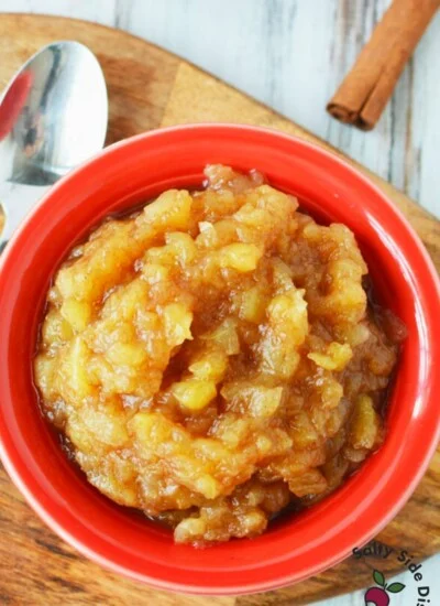 bowl of homemade applesauce next to a spoon.