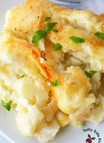 cauliflower au gratin piled on a white plate.
