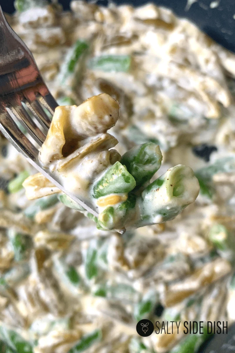 Cream cheese green beans on a fork ready to serve