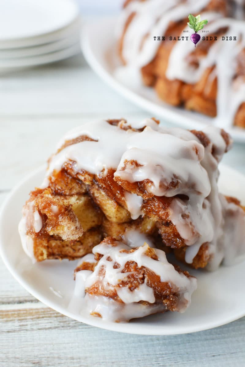 Cinnamon Roll Monkey Bread with icing on a plate ready to serve