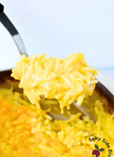scooping casserole in a spoon.
