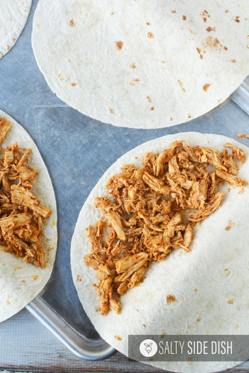 shredded chicken on half of torilla
