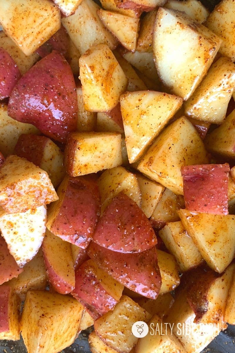 red potatoes in bowl with oil and chili powder on them
