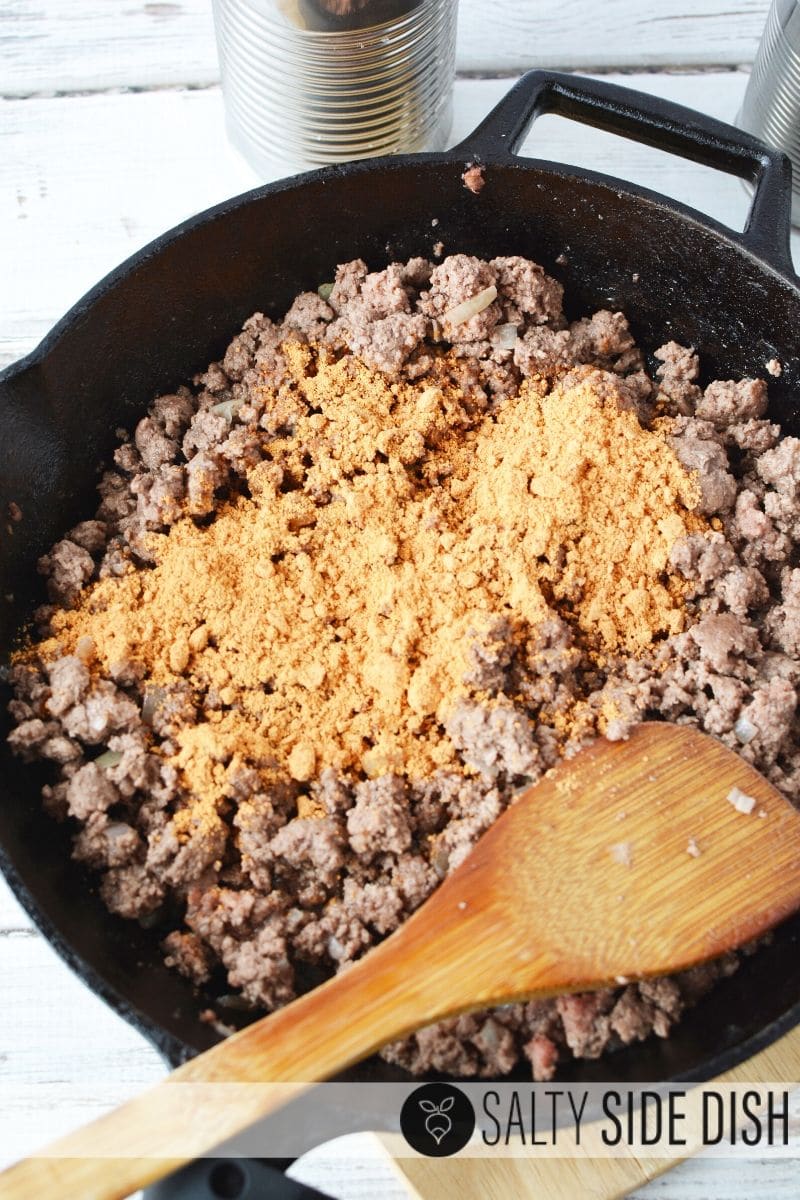 ground beef in cast iron pan with taco seasonings