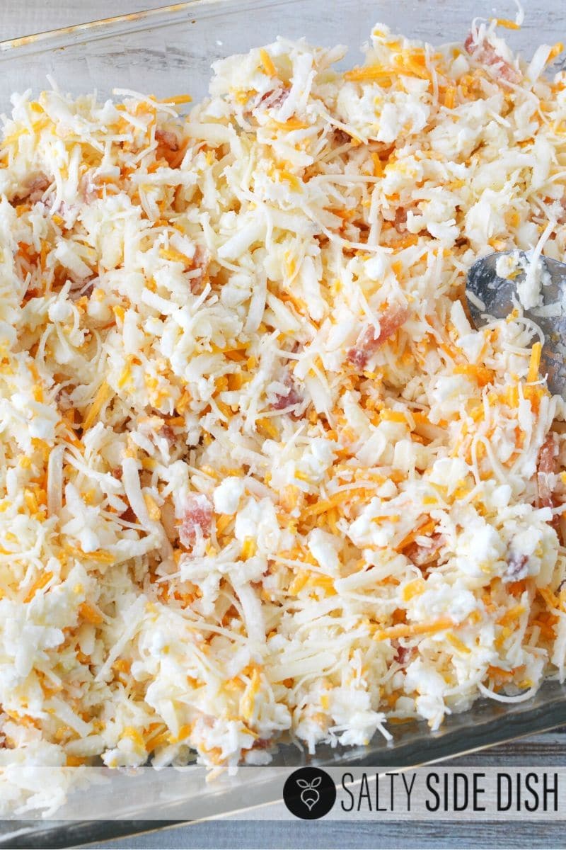 Mix bacon, hash browns and cheeses in a bowl and dump into casserole dish that has been sprayed with cooking spray