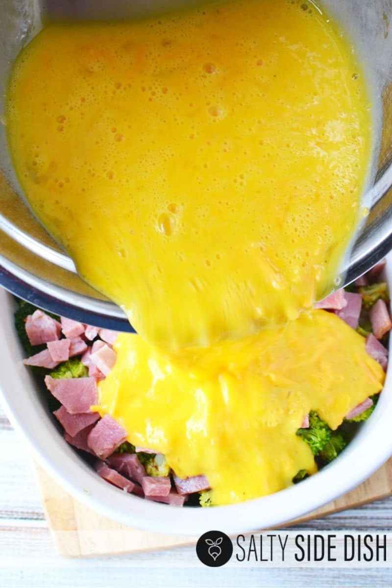 pouring egg on casserole