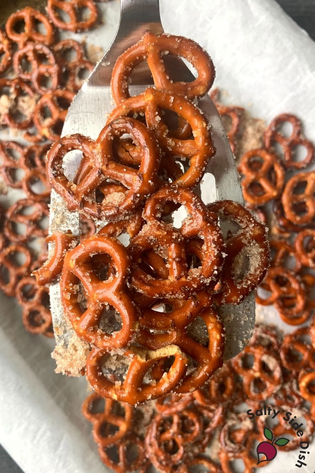 spatula holding hard cinnamon sugar pretzels.