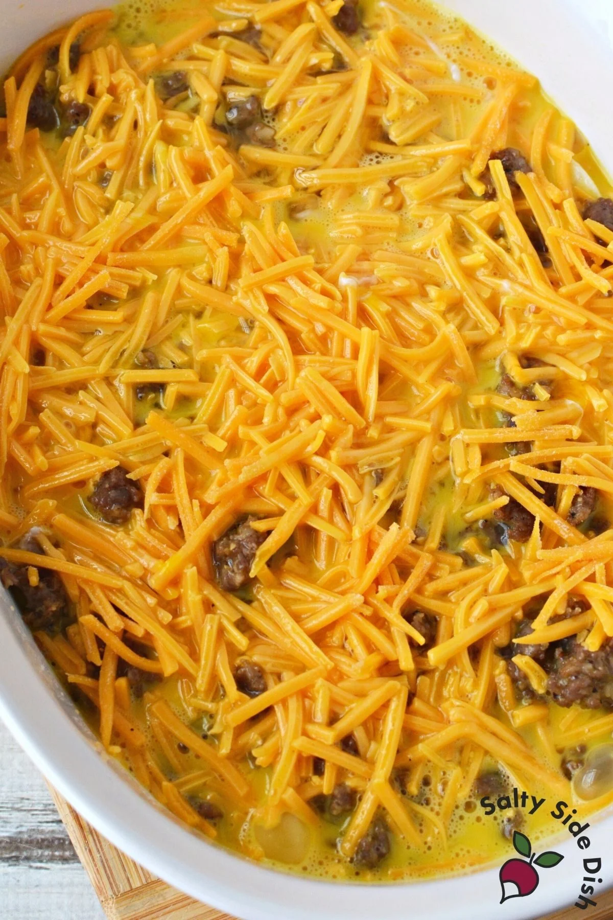 layers of biscuits, gravy, cheese and eggs in a baking dish.