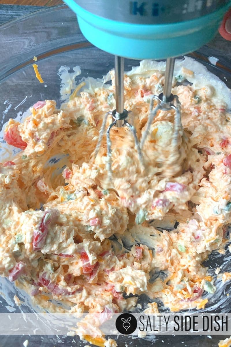 pimento cheese dip with cream cheese being made with hand mixer