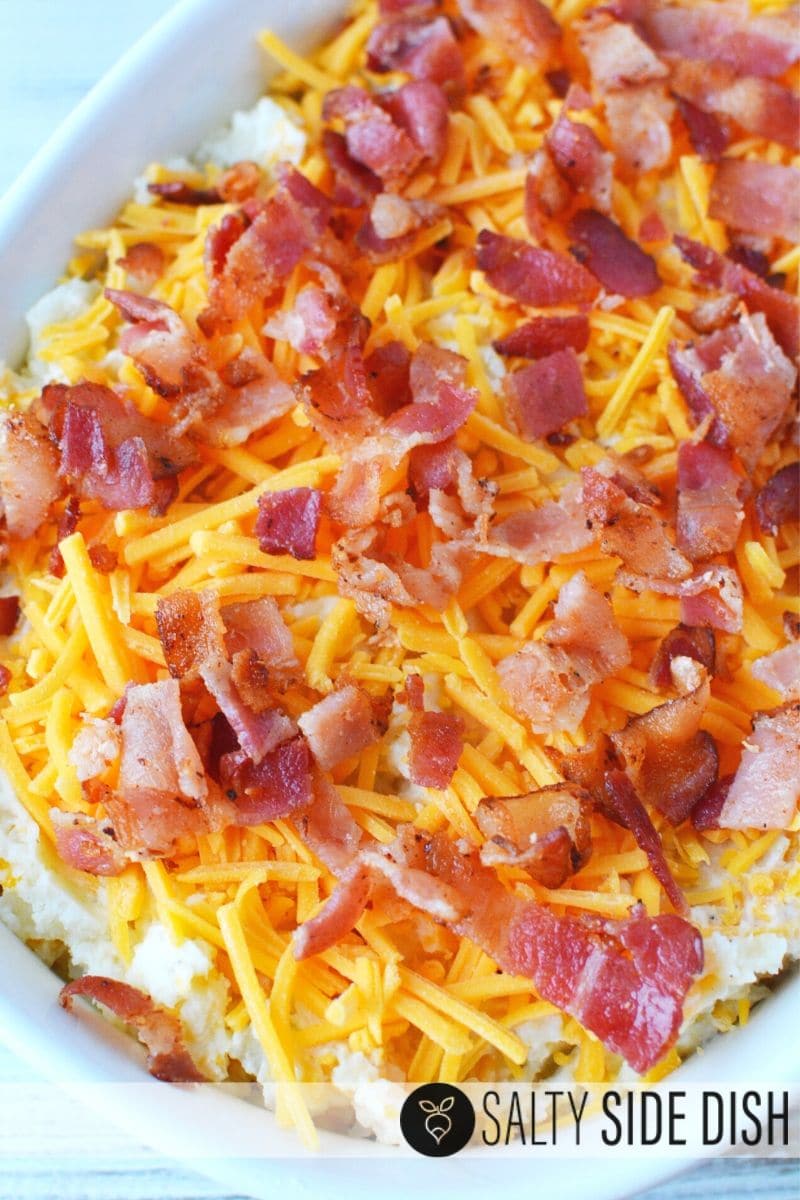 Top Loaded Twice Baked Potato Casserole with tons of delicious cooked bacon