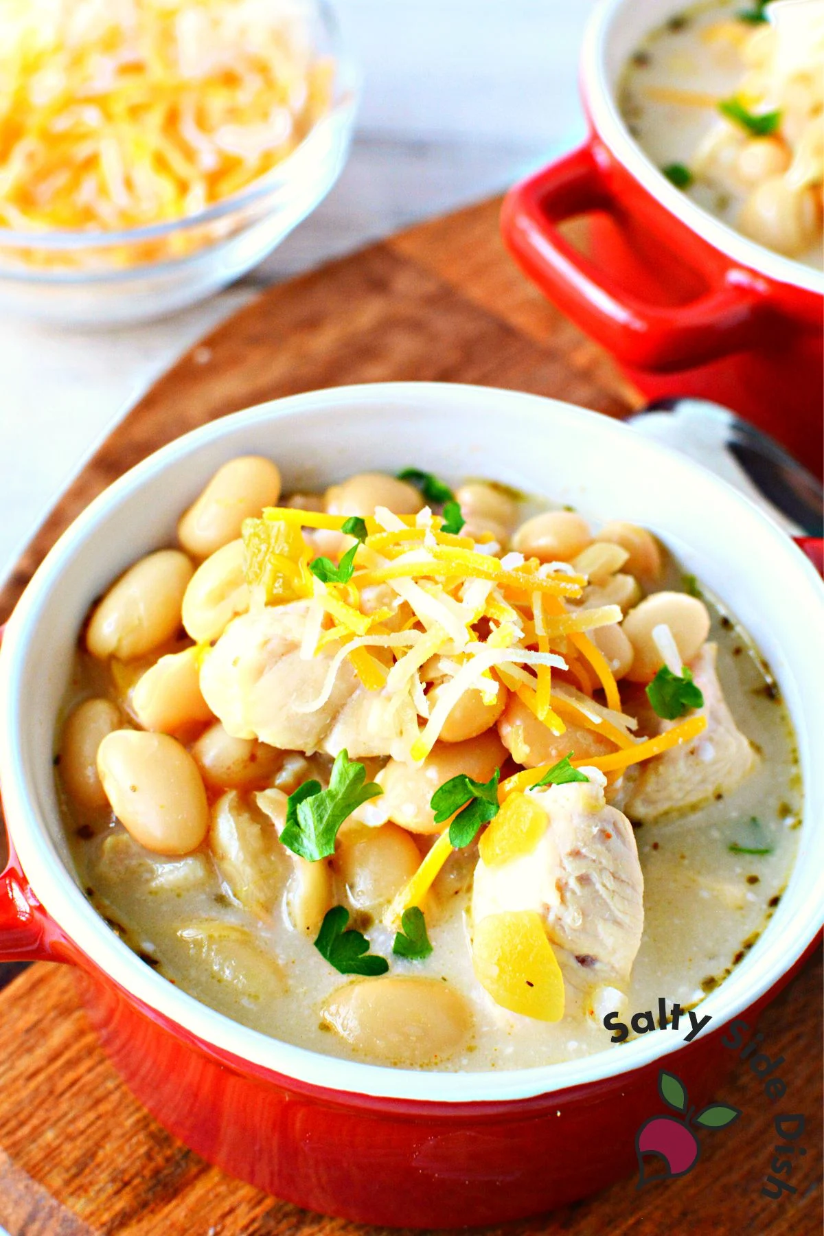 white chicken chili in a red bowl.