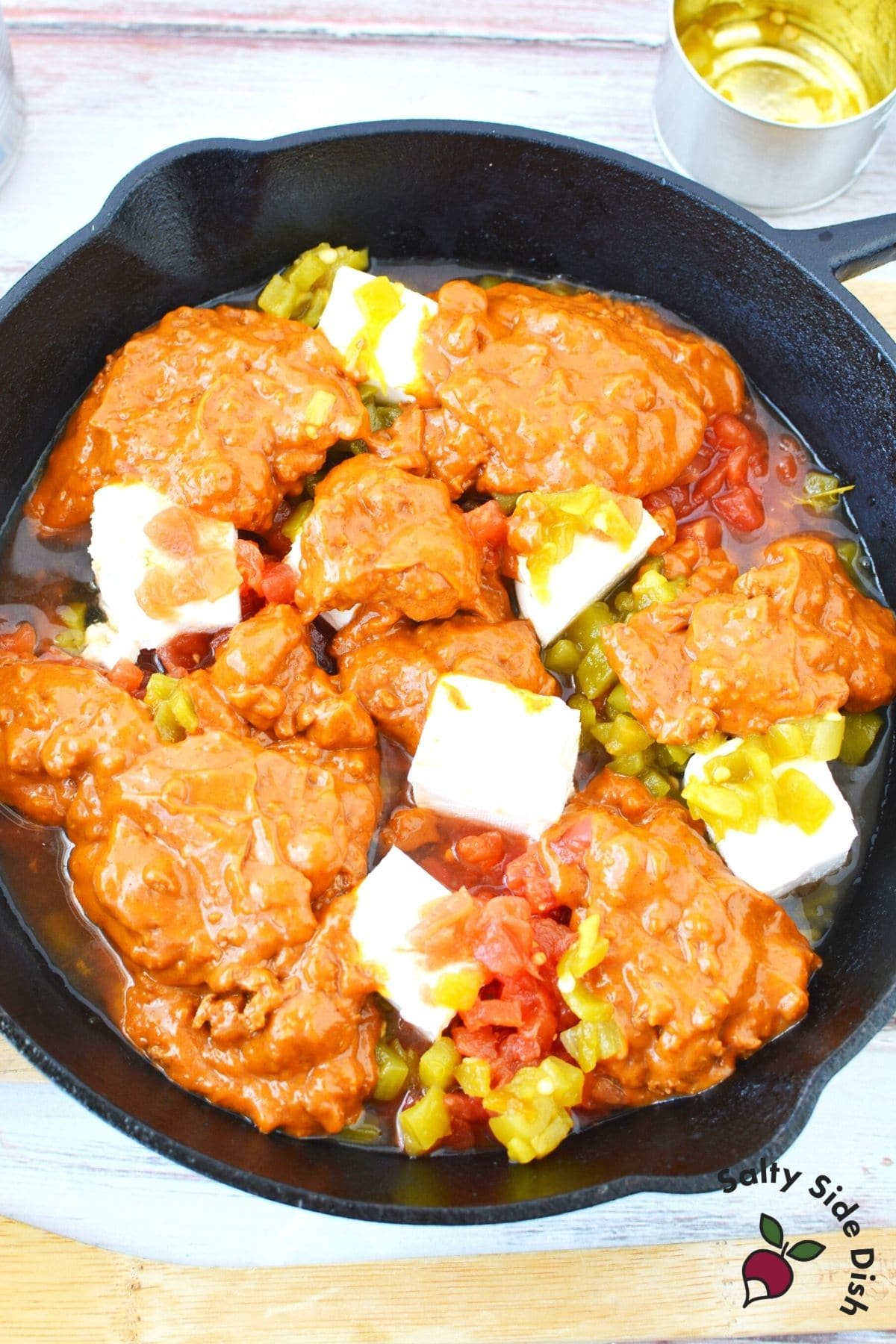 chili cheese dip with cream cheese in a cast iron pan