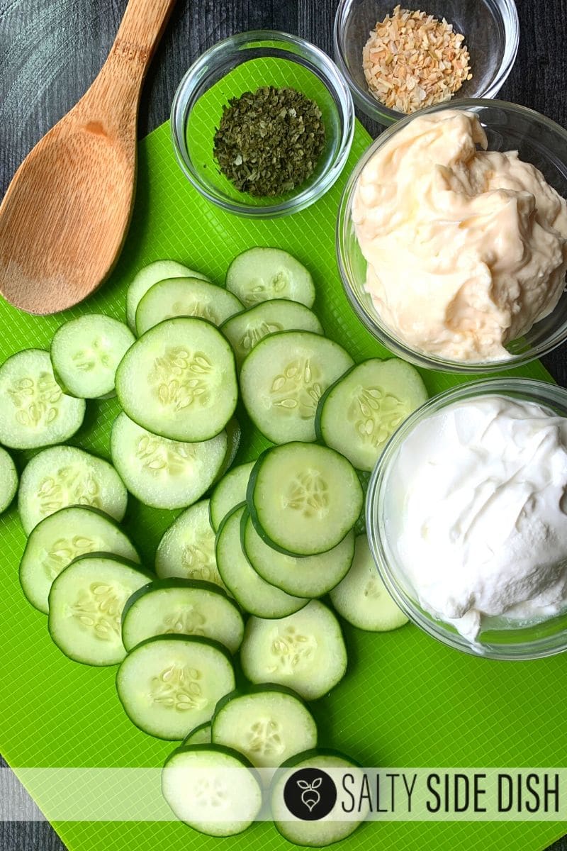 keto friendly addicting dip spread with sliced cucumbers, dried dill, parsley, sour cream, minced onions and all prepped for recipe creation