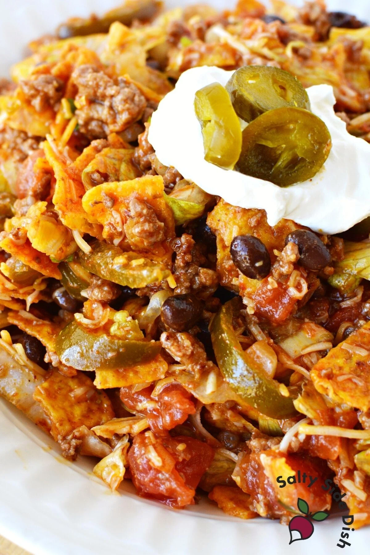 Doritos taco salad with sour cream.