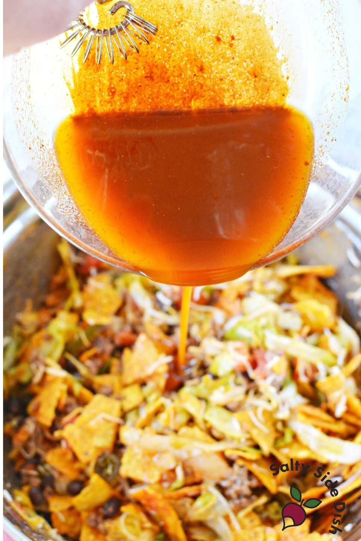 pouring doritos taco salad.
