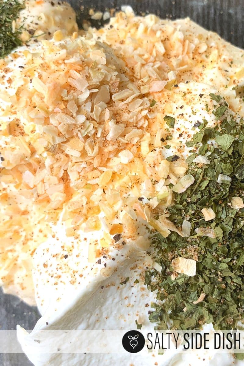 Cucumber dip ingredients prepped and poured in a bowl ready to be mixed up for the dip
