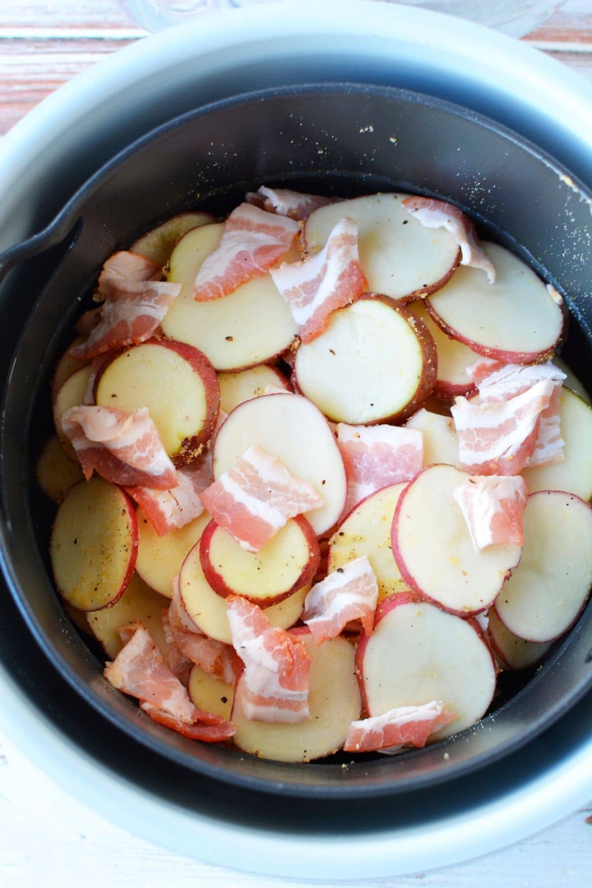 adding potatoes to air crisp basket uncooked
