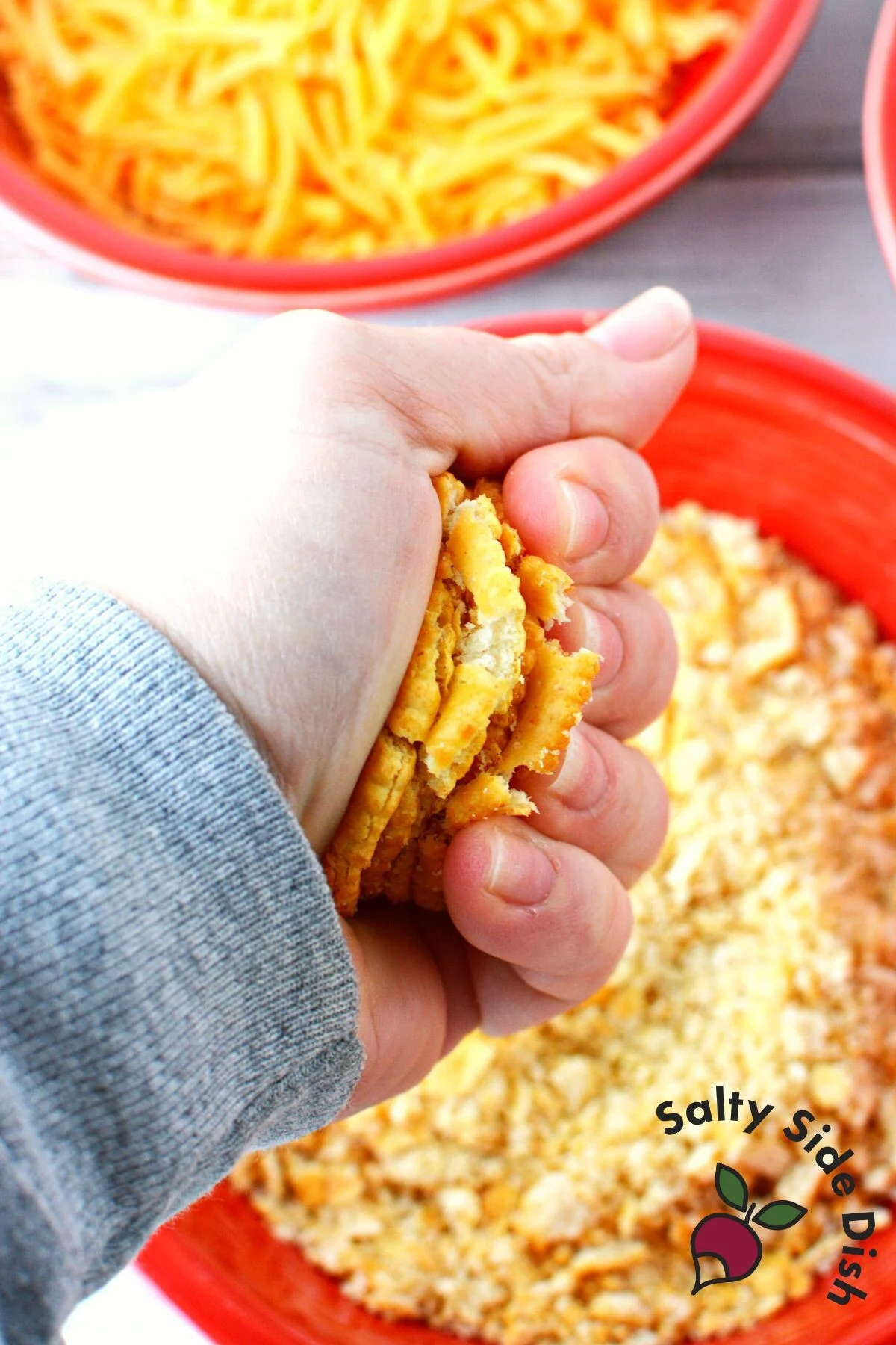 crushing ritz crackers in a bowl.