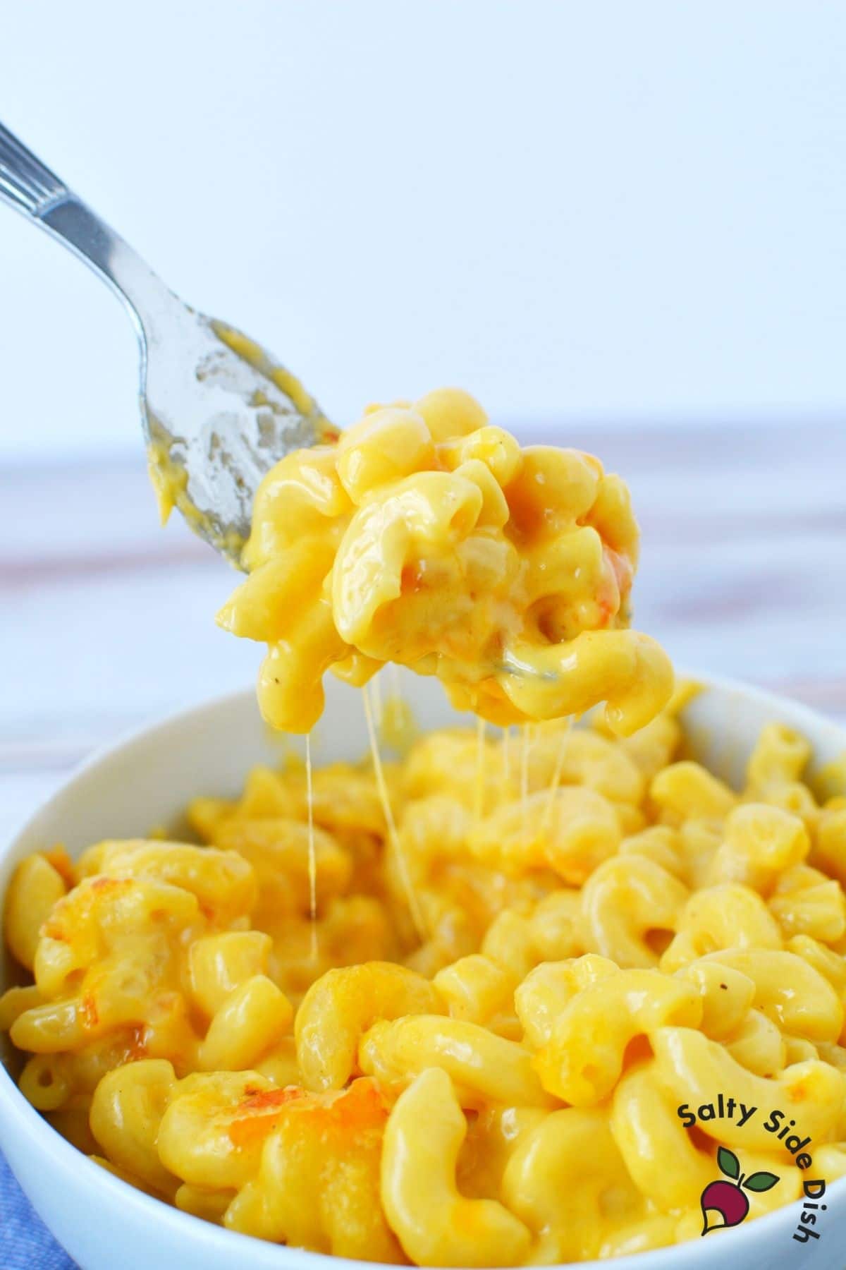 cheesy macaroni and cheese on a fork