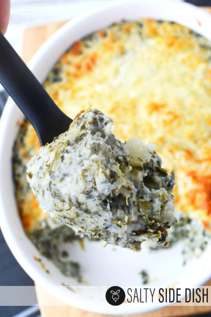 Serving spinach mashed potatoes side dish with creamy mashed and healthy spinach on a black spoon
