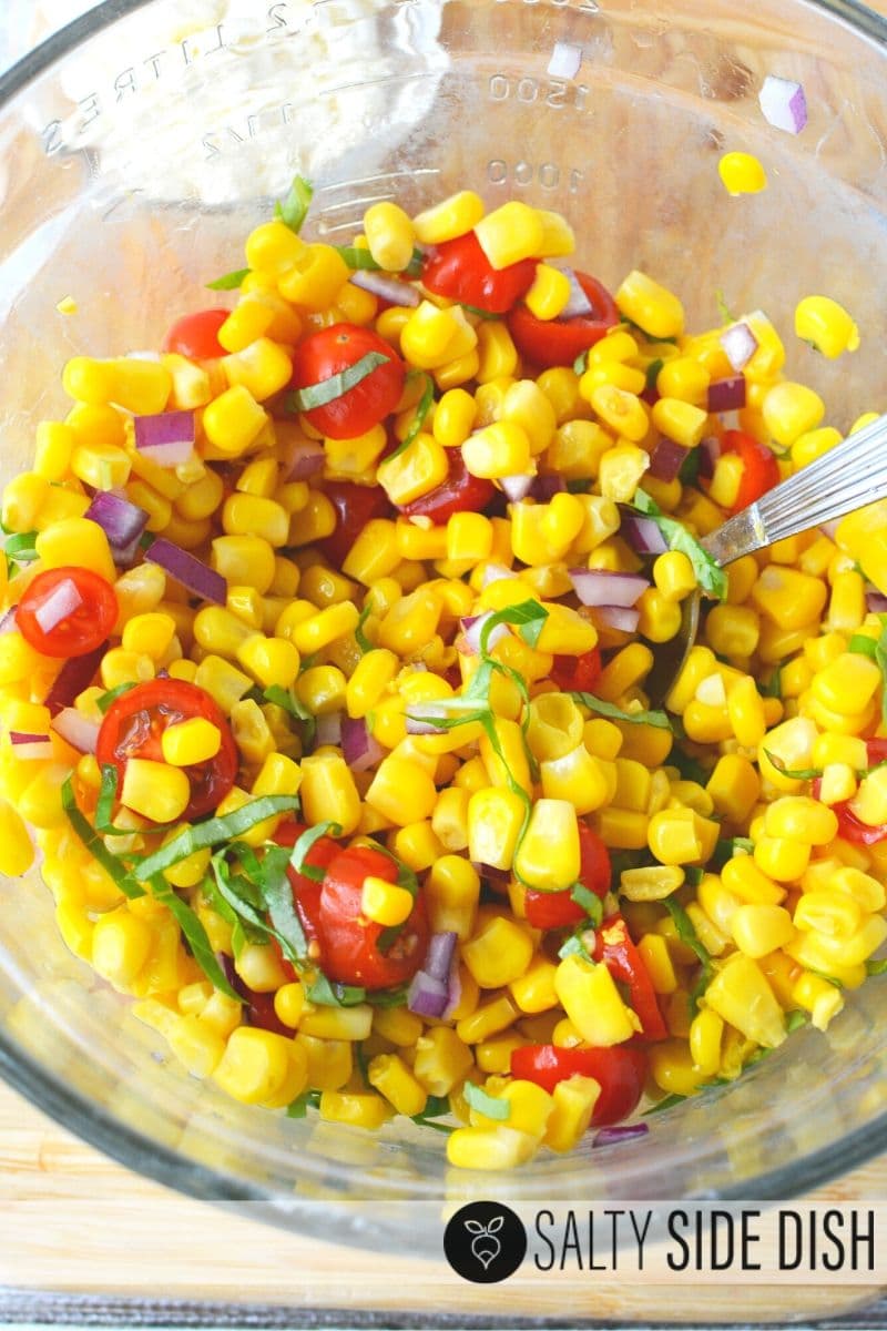 Mix up cherry tomatoes and drained corn with seasonings and herbs for the perfect cold side salad recipe