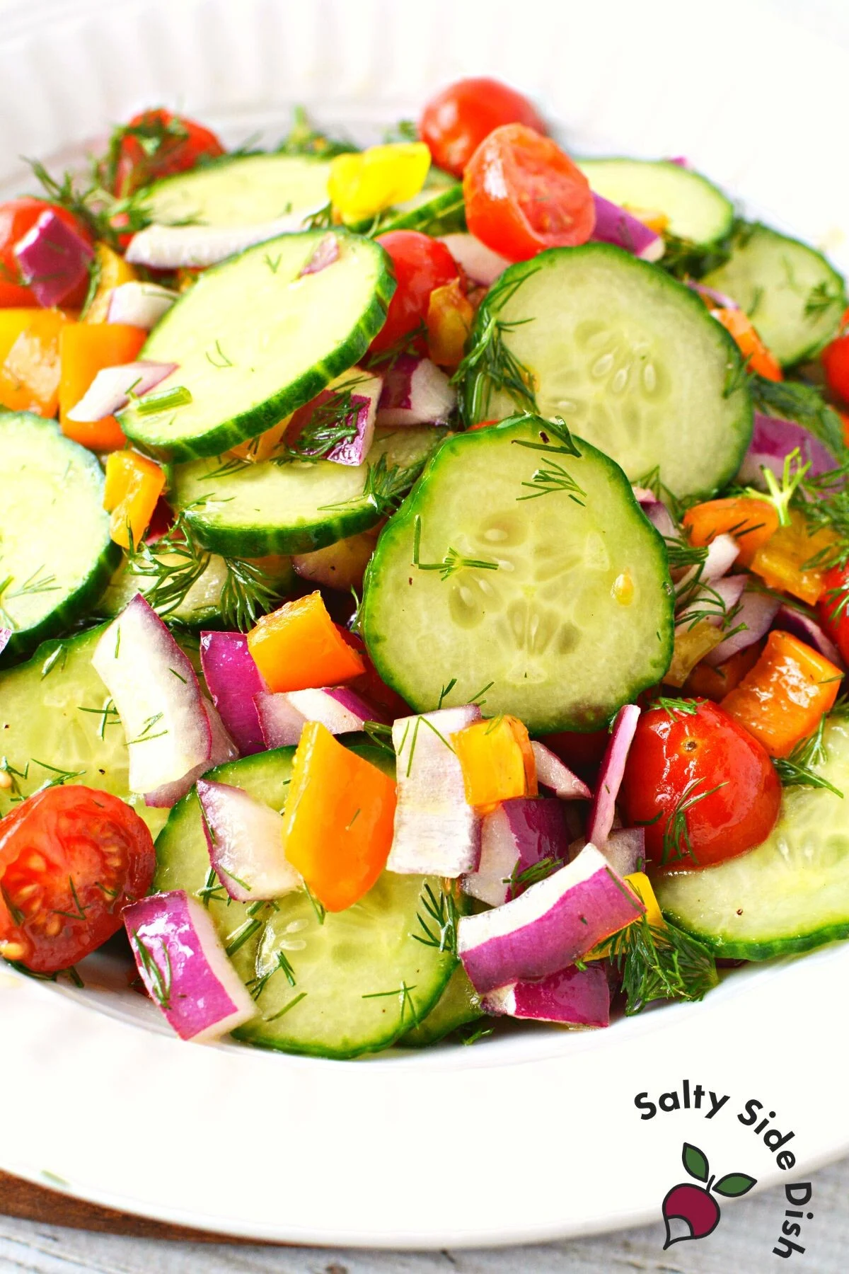 vinegar cucumber salad in a white bowl.