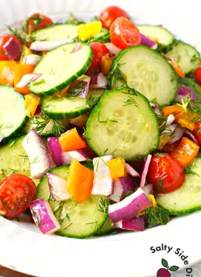 vinegar cucumber salad in a white bowl.