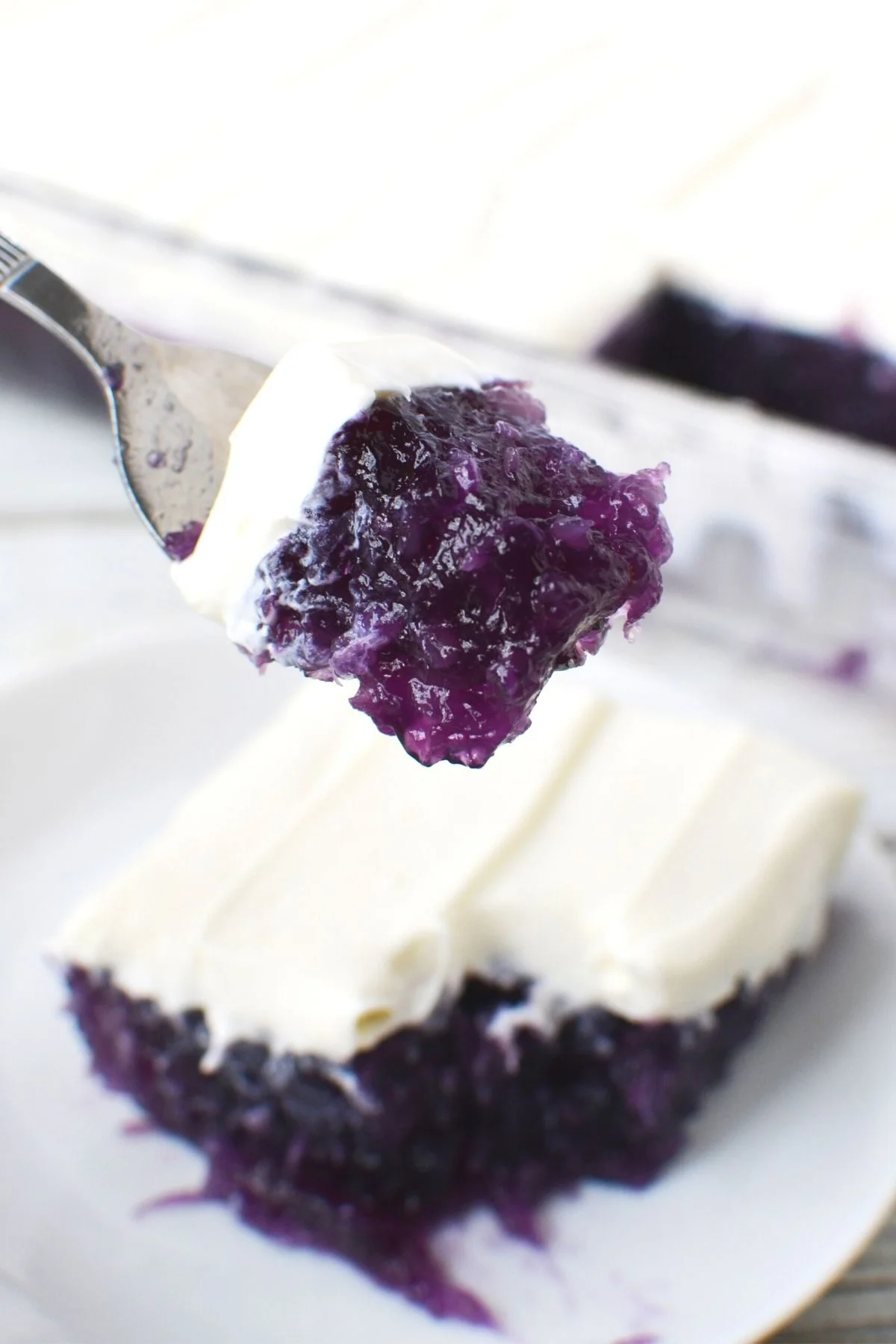 fork with blueberry salad and cream cheese on it.