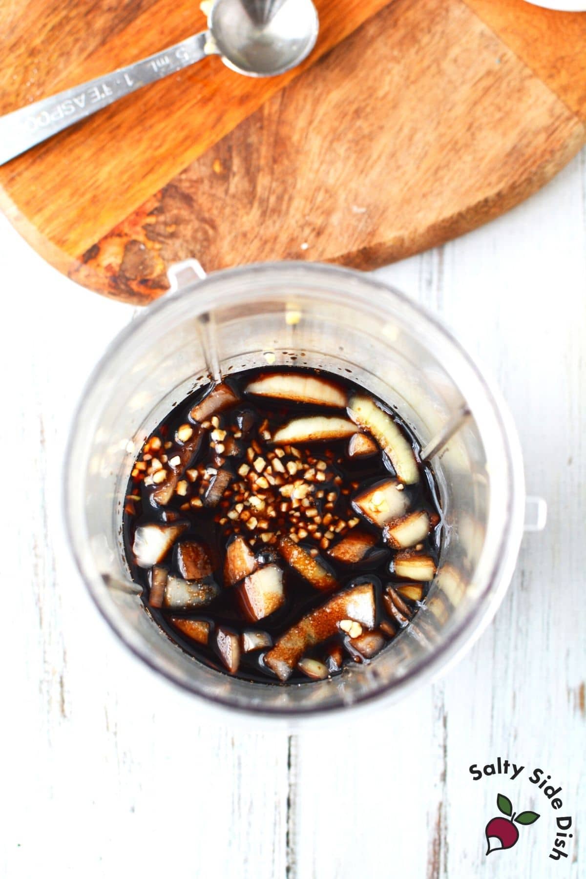 adding dressing ingredients to a magic bullet