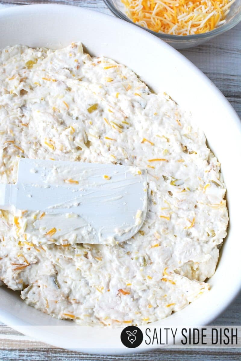 cream cheese enchilada dip spread in casserole dish ready for the oven