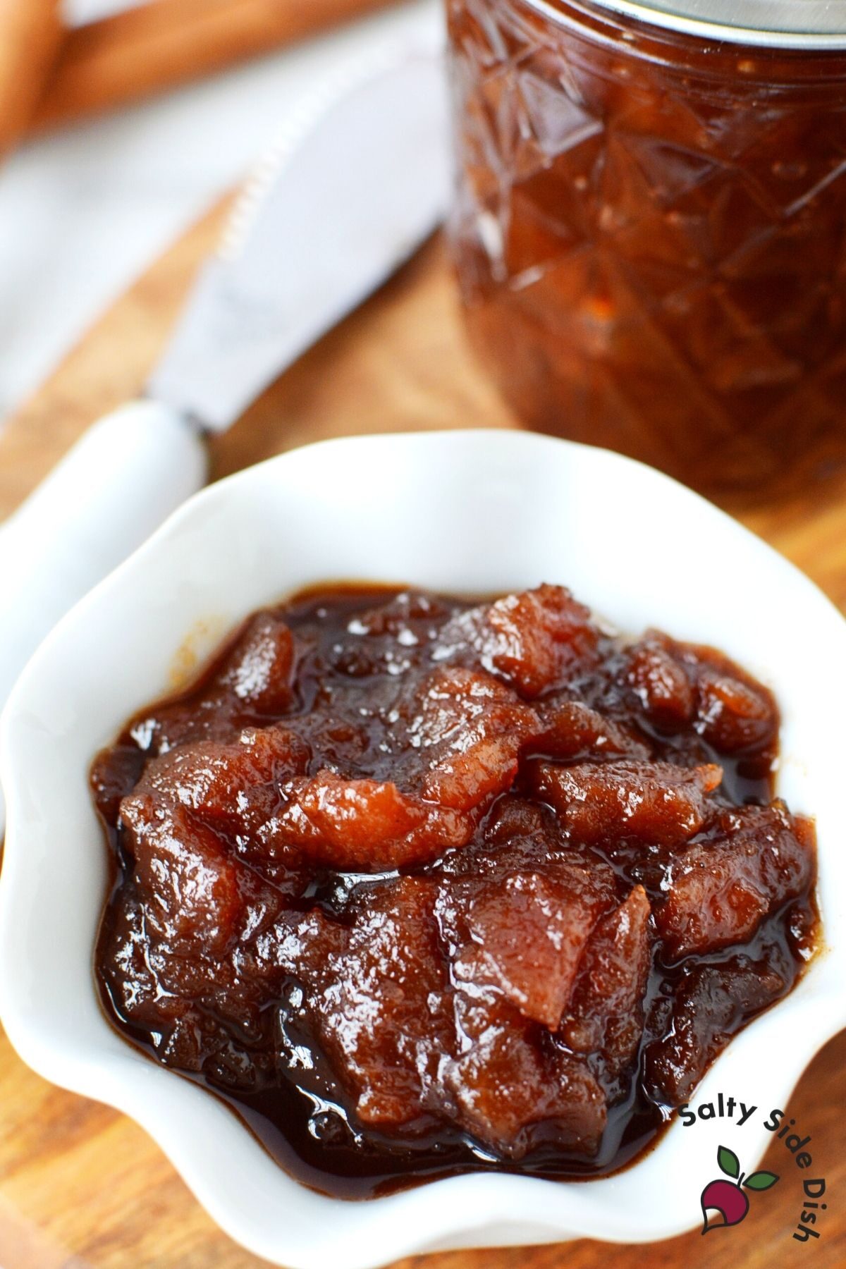 apple butter recipe with chunks of apples, sitting in a bowl ready to serve up