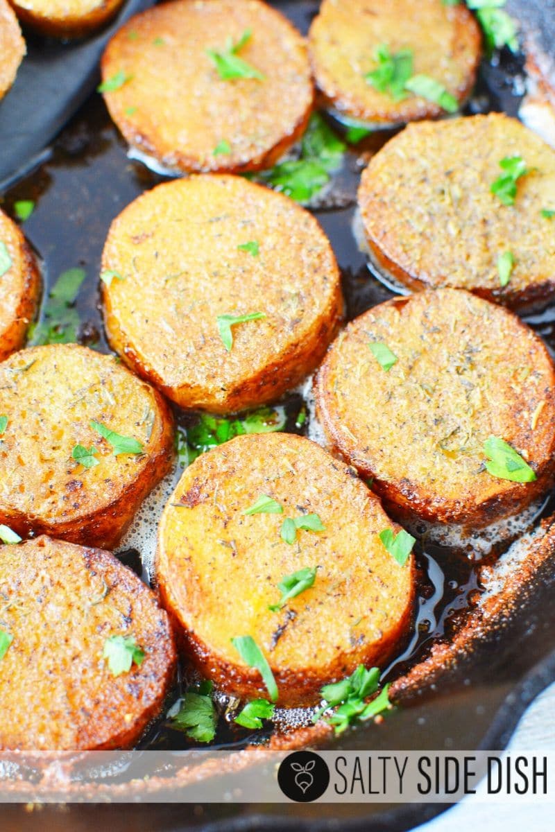 Finished oven melting potatoes sitting in a cast iron pan