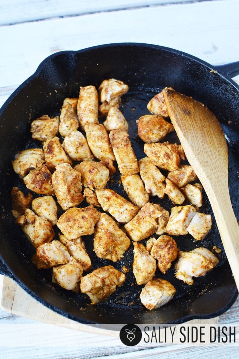seasoned chicken with homemade Cajun seasoning (you can blacken if you like) sitting in a cast iron pan