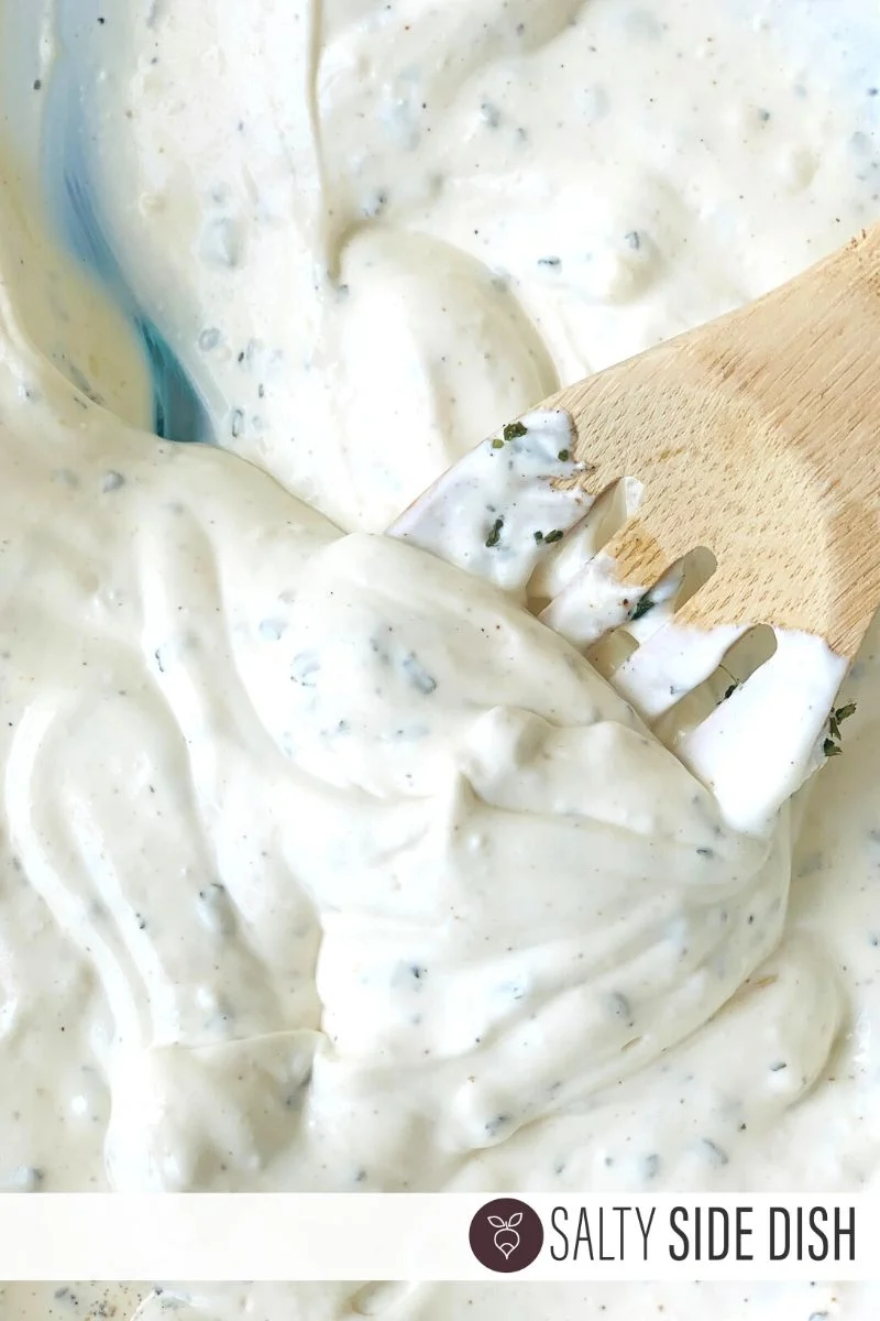 Greek Yogurt Veggie Dip Recipe being stirred by a wooden spoon