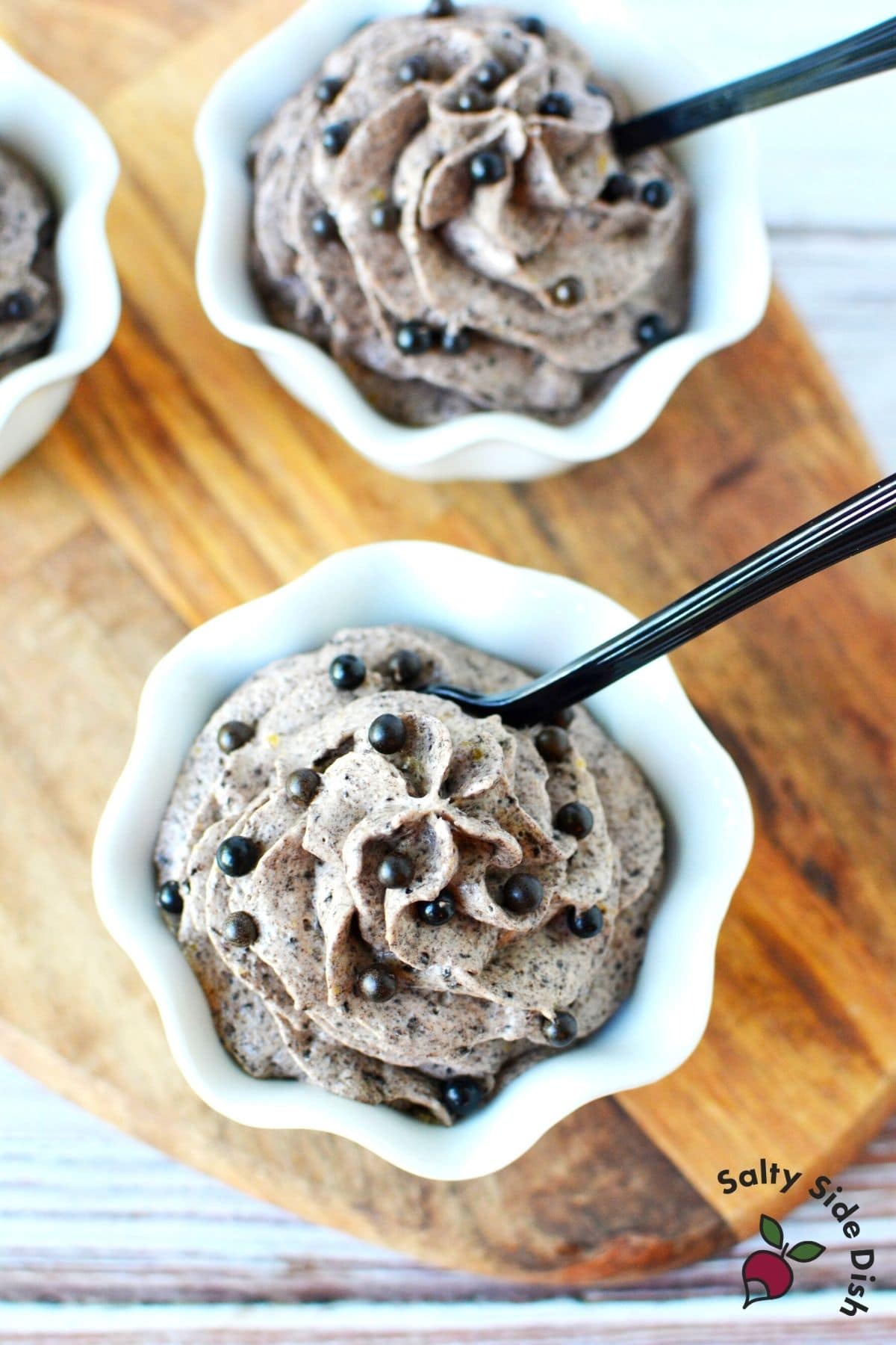 the grey stuff in a white bowl with black tasting spoons