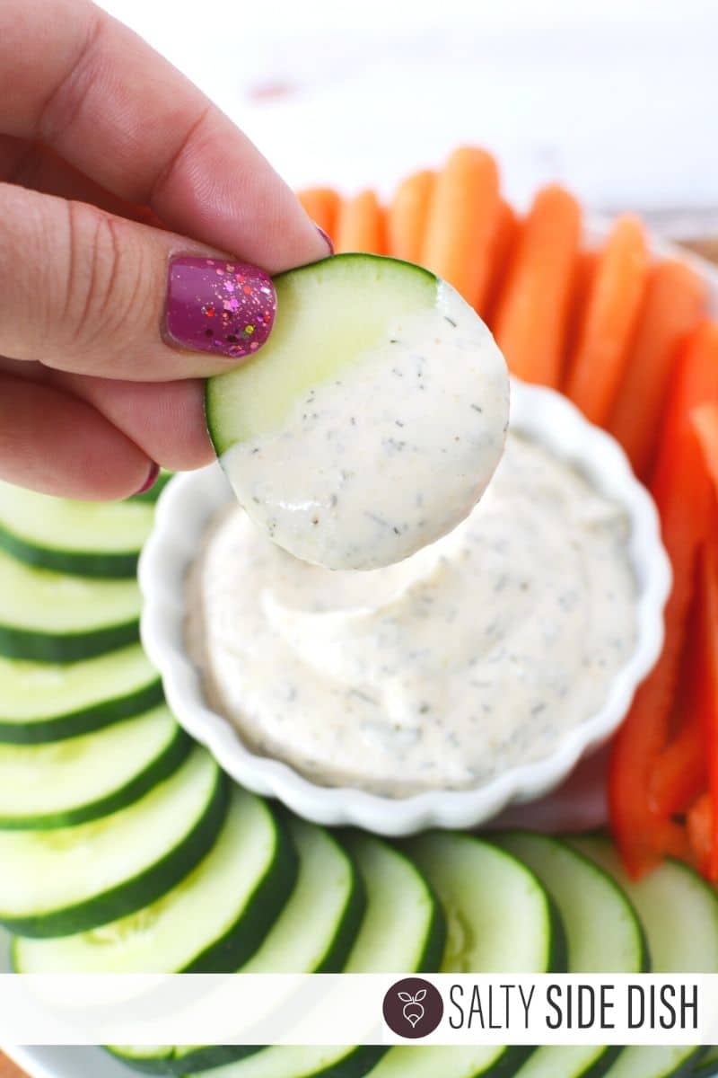 Ranch dip done and being dipped with cucumber