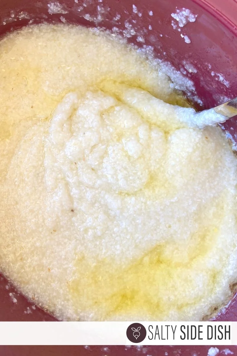 big scoop of finished grits ready to be stirred and lots of butter