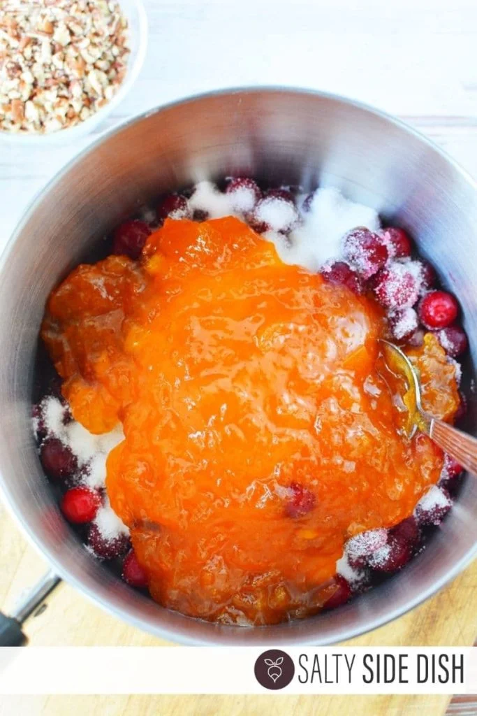 Cranberries, sugar, and preserves inside the pot for dip