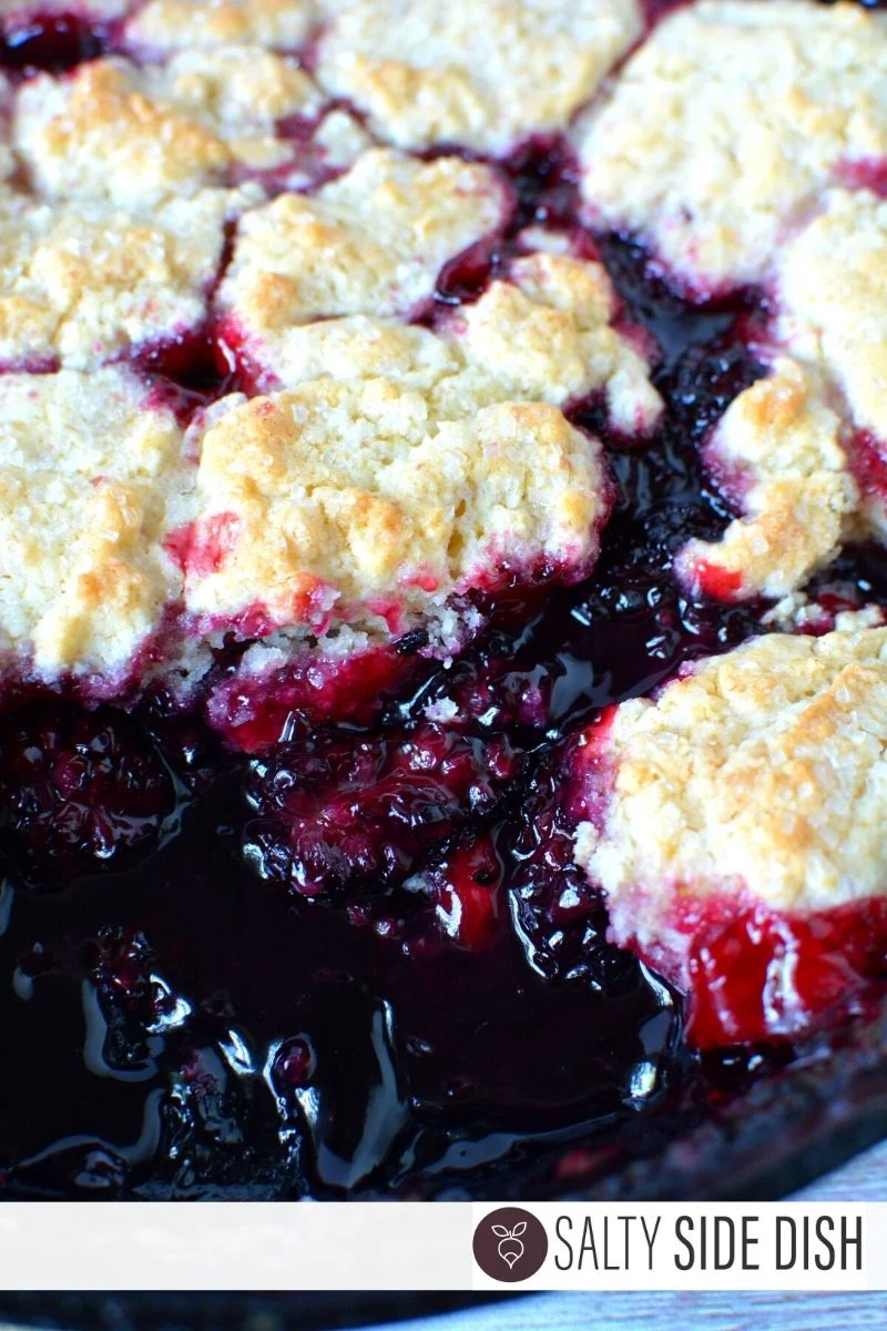 Blackberry cobbler with fresh blackberries and a homemade biscuit topping with course sugar,