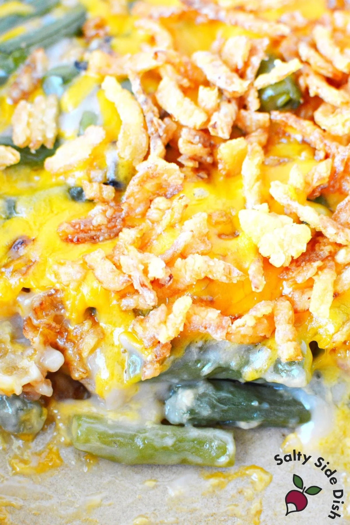 a casserole dish full of green bean casserole with fresh green beans.