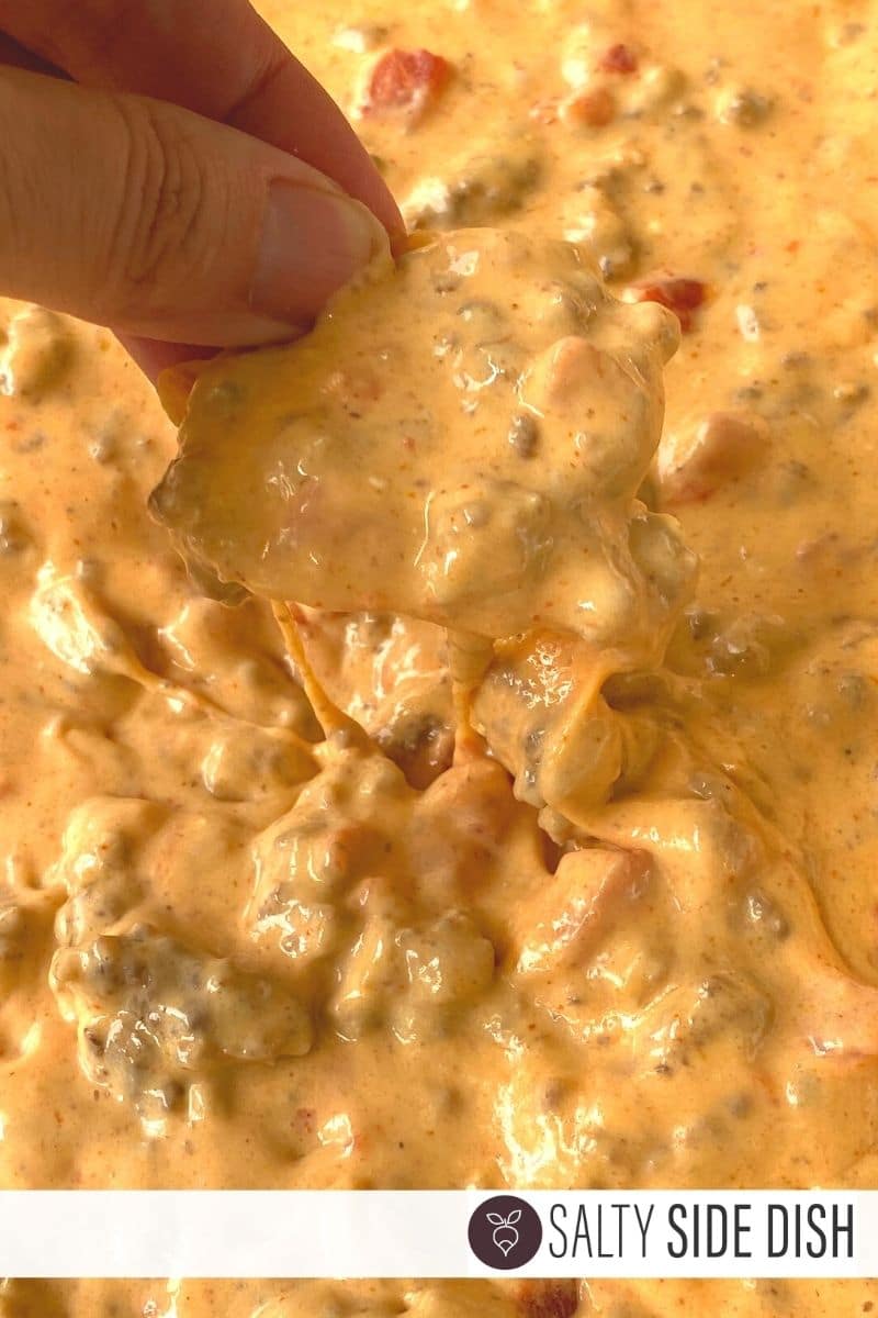 football queso dip recipe with chips being dipped into already melted Queso