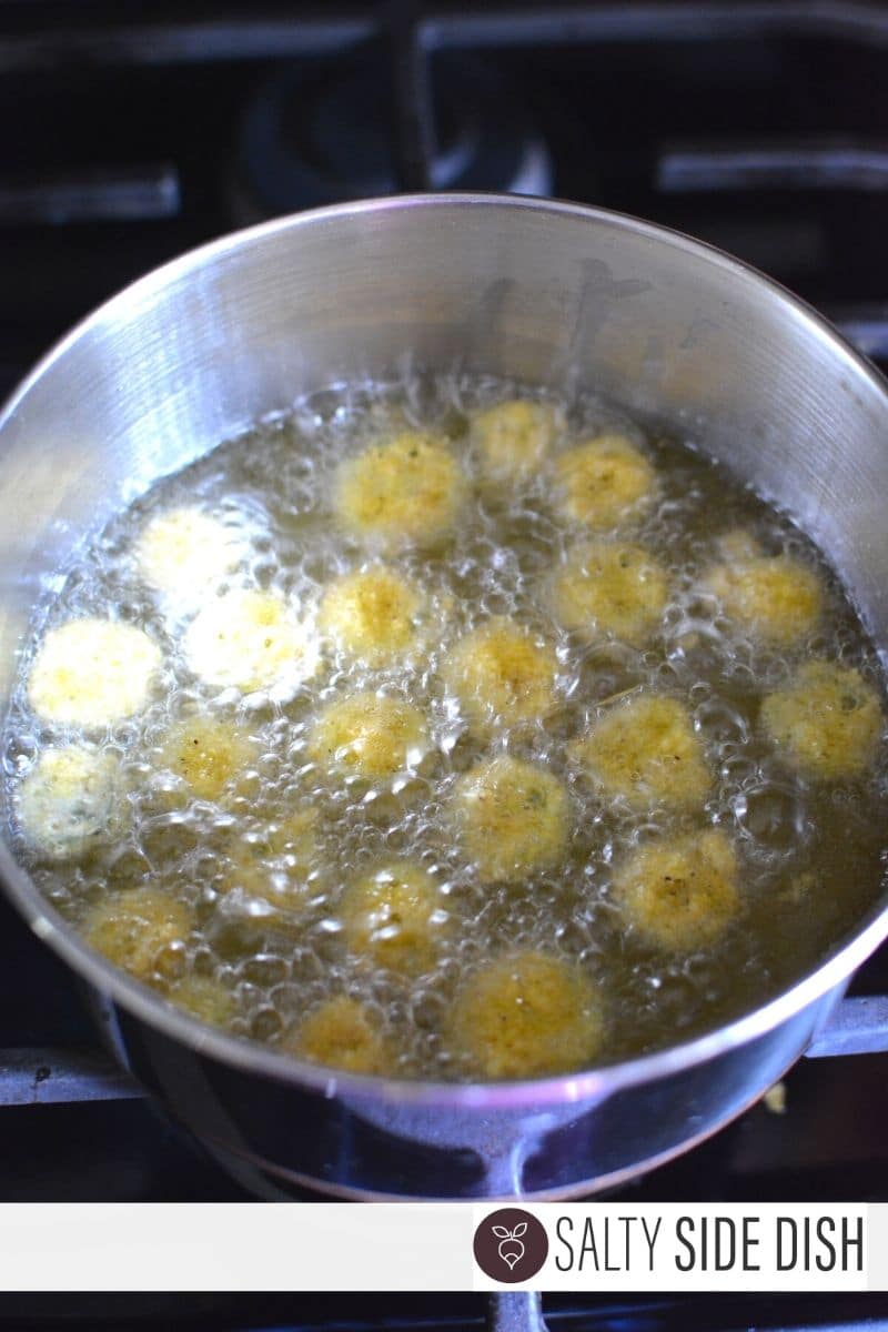 fried okra in a deep pan with oil over the top