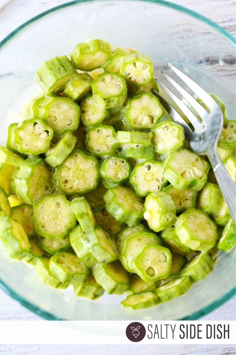 fried okra sitting in egg wash