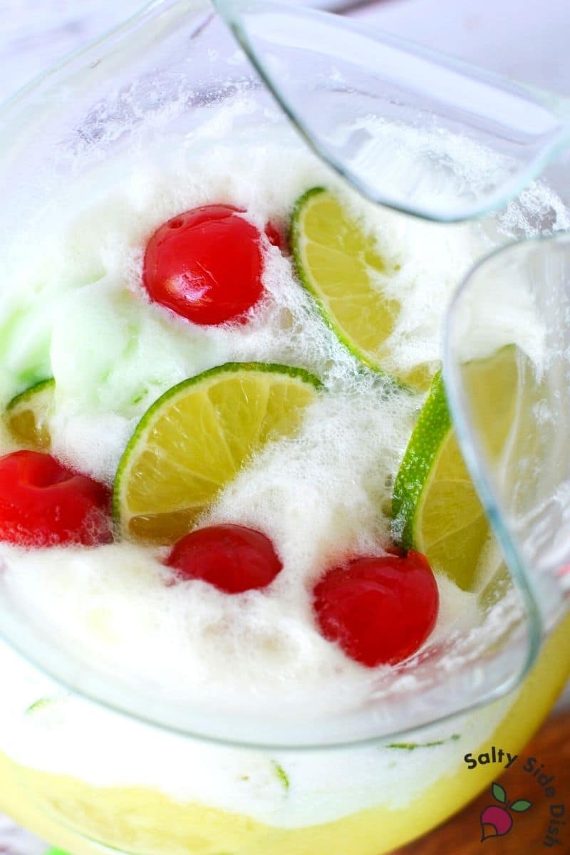 fresh cherries and lime slices in the top of party punch