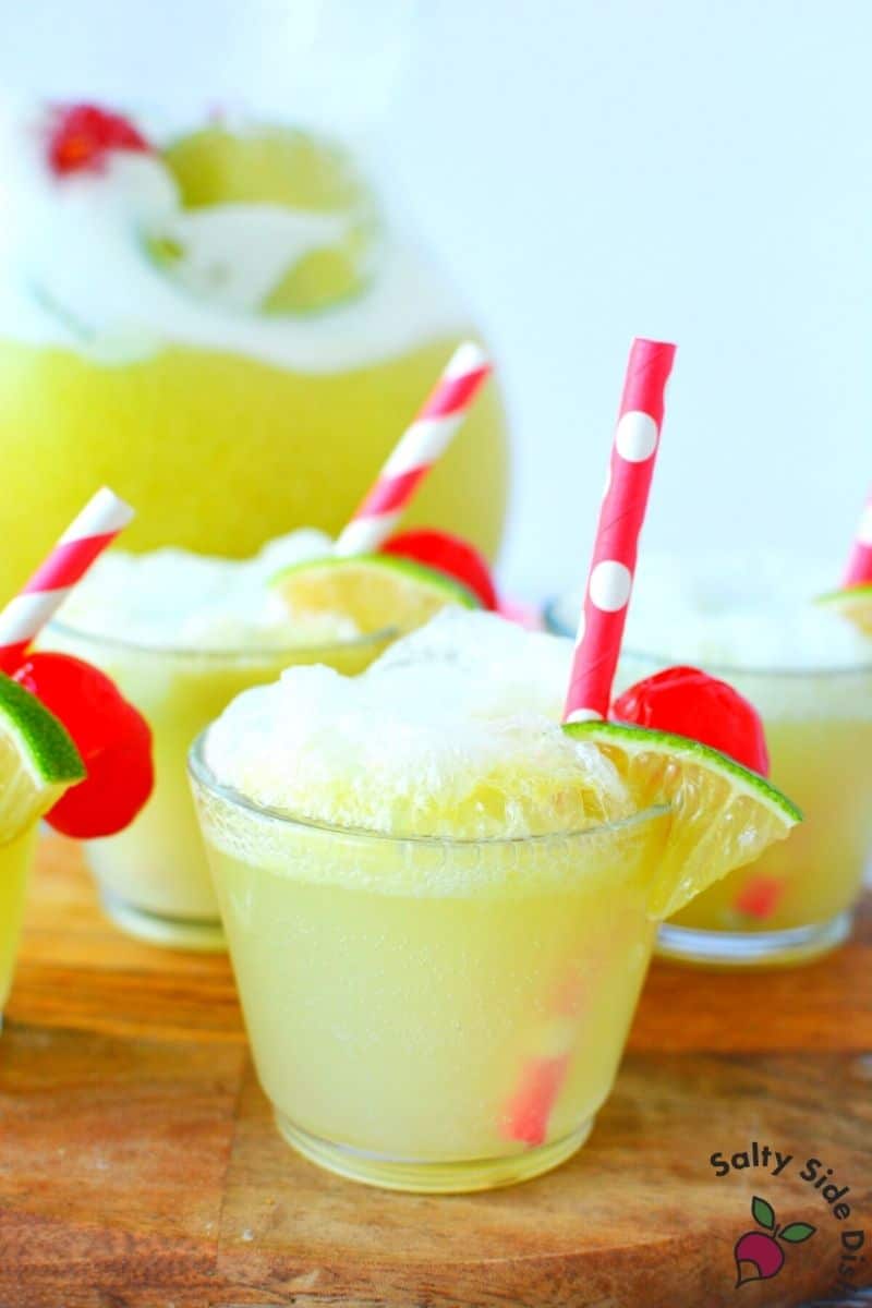 easy to serve Lime Sherbet Party punch wtih straws and little lime pieces