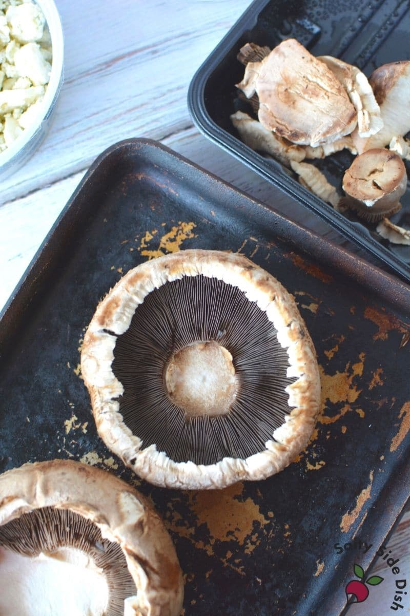 Portobello Mushrooms sitting on baking sheet