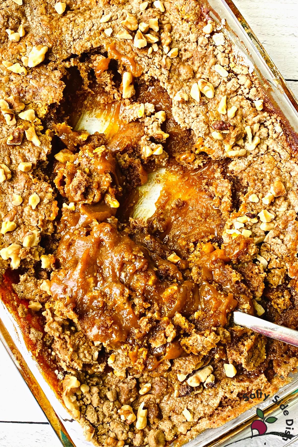 oven baked cream cheese pumpkin dessert cake with a spoon.