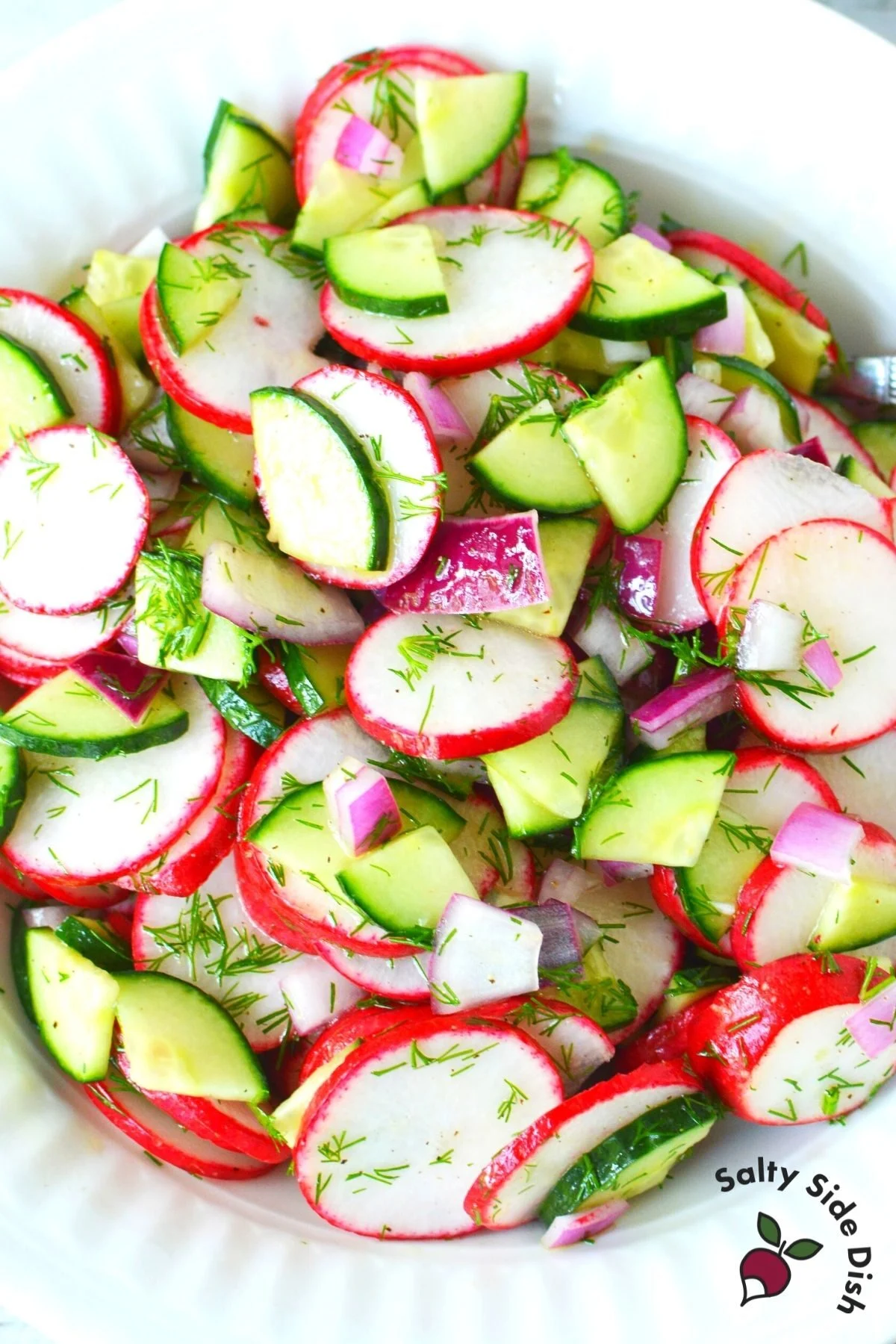 piles of radish and cucumbers in a bowl.